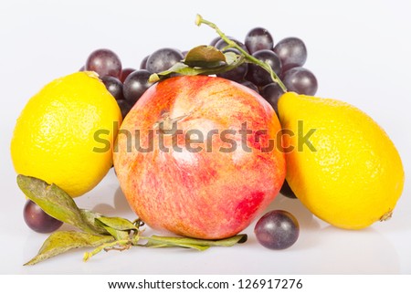 pomegranate and grapes under the white background