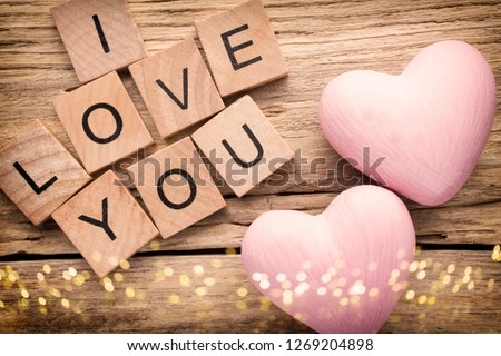 Red heart on old wooden background - Stock Image. I love you, cast out of wood kubik.