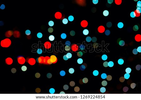 red and light blue bokeh on black background