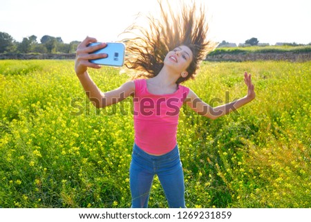Teen girl selfie video photo in spring meadow moving hair