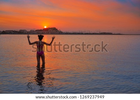 Girl silhouette at beach sunset open arms yoga mudras finger standing