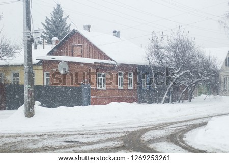 Wooden house in a nature area covered with freshly fallen snow