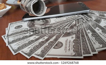 american dollars and cell phone
