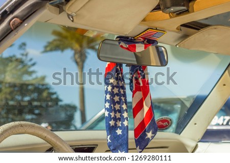 Vintage car, american flag ribbon, front view of old car. America patriotism. Vintage fashion. USA flag