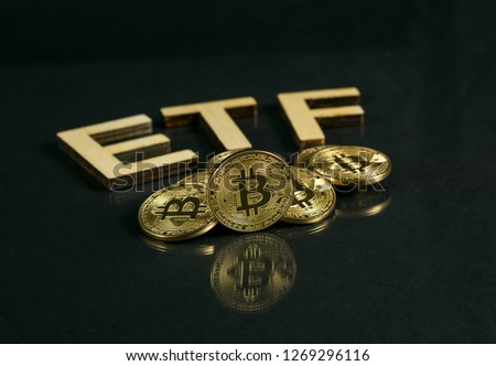 Bitcoin coin with ETF text Put on wooden floor, Concept Entering the Digital Money Fund. Royalty-Free Stock Photo #1269296116
