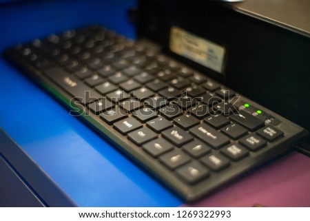 black keyboard on the blue desk