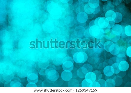 Turquoise bokeh blurred lights background. Garlands decoration for the new year celebration.