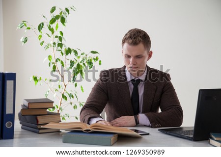 a man works in the Office at the computer business clerk