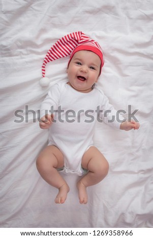 Smiling baby girl wearing a Santa Hat