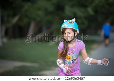 Girl wearing helmet and safety gear medium close up