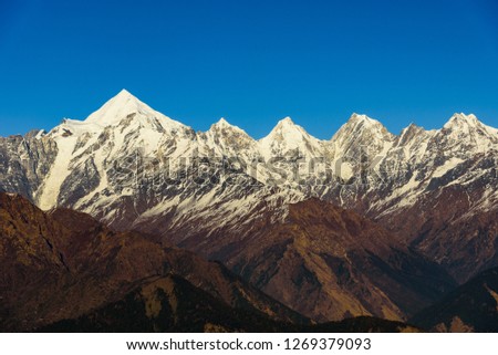 View of Snow cladded Panchchuli peaks falls in great Himalayan mountain range  & alpine grass meadows enroute to Khalia Top trekk trail at small hamlet Munsiyari, Kumaon region, Uttarakhand, India. Royalty-Free Stock Photo #1269379093