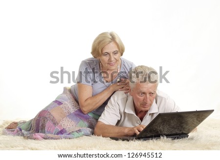 Mature couple relaxing at home on a white background