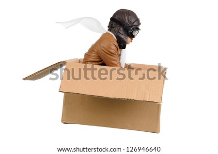 Young boy pilot flying a cardboard box isolated in white Royalty-Free Stock Photo #126946640