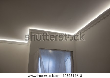 repair, illumination of the ceiling of the box. complex structures made of plasterboard. hidden light, game of shadows. Royalty-Free Stock Photo #1269514918