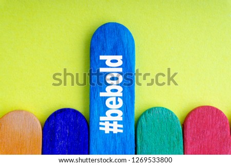 Colorful wooden or ice cream stick and words BE BOLD with selective focus and crop fragment. Business and education concept