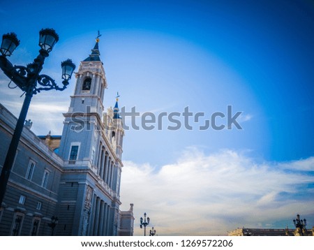 A beautiful photo of the exterior facade of one of the Almudena cathedral as seen from the popular Bailen street. The cathedral is located in front of the Royal Palace of Madrid, in Spain, Europe