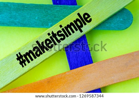 Colorful wooden stick and words MAKE IT SIMPLE with selective focus and crop fragment. Business and education concept