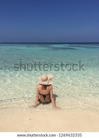 Girl with straw hat on the beach (Ari Atoll, Maldives)