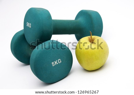 Fitness  concept - dumbbells, apple and measure tape
