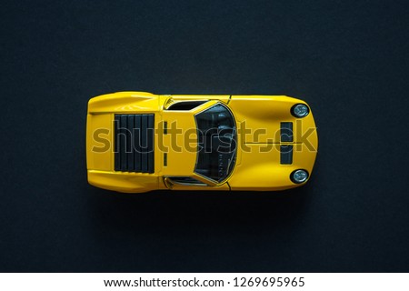 Metal toy sports car of yellow color. View from the top Royalty-Free Stock Photo #1269695965