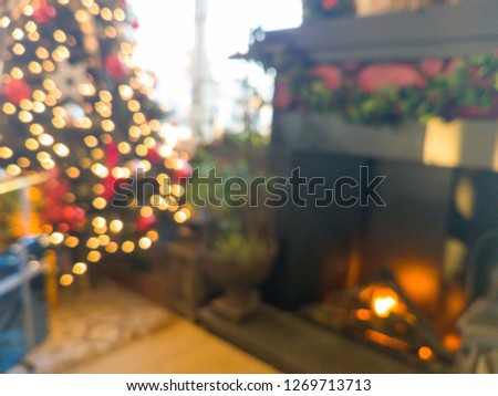 decorated christmas tree front of the fireplace, blurred focus 