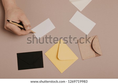 Hand holding blank envelope and  letter mockup 