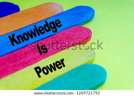 Colorful wooden stick and words KNOWLEDGE IS POWER with selective focus and crop fragment. Business and education concept