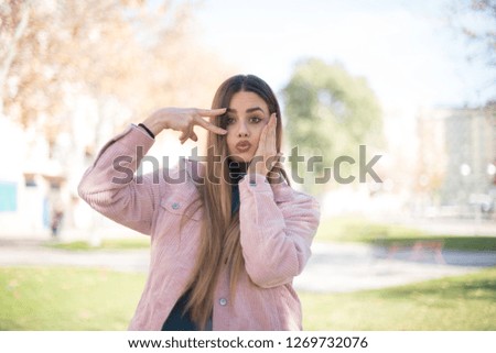 Leisure lifestyle people person celebrate flirt coquettish concept. Beautiful pretty cheerful gorgeous blonde showing making v-sign near eyes wearing casual clothes standing outdoors.