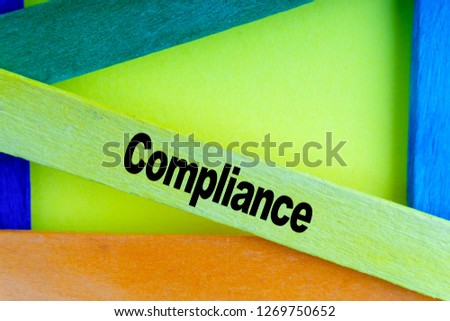 Colorful wooden stick and words COMPLIANCE with selective focus and crop fragment. Business and education concept