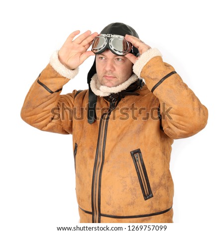 Portrait of a vintage pilot with leather cap, scarf and aviator glasses isolated on white background