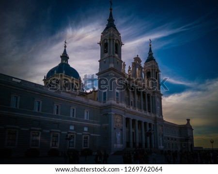 A beautiful photo of the exterior facade of one of the Almudena cathedral as seen from the popular Bailen street. The cathedral is located in front of the Royal Palace of Madrid, in Spain, Europe