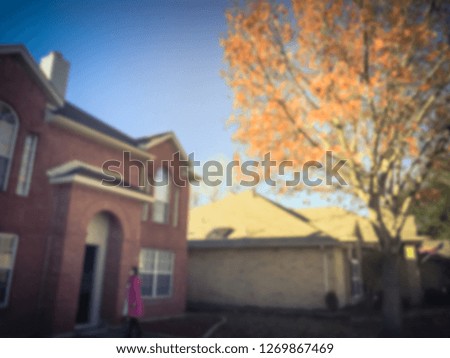 Blurred abstract front porch entrance of single family house with detached garage at fall season in Texas, America
