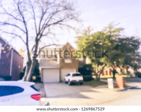 Motion blurred single family house with attached garage and parked car in Texas, America