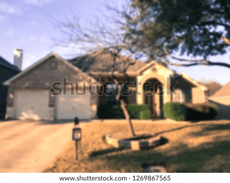 Vintage tone motion blurred front porch entrance of single family house with detached garage at fall season in Texas, America