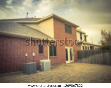 Blurred abstract backyard of single family house with thick carpet of dried leaves in fall season