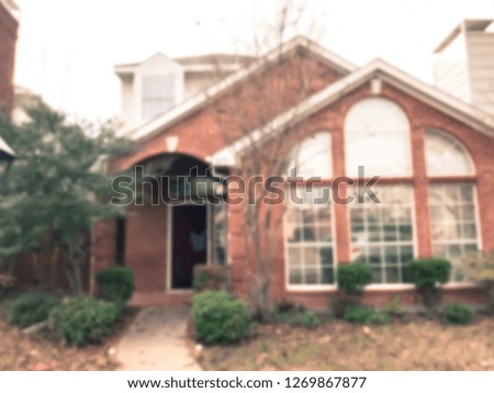 Vintage tone motion blurred front porch entrance of single family house with detached garage at fall season in Texas, America