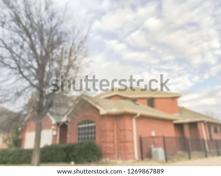 Blurred abstract front porch entrance of single family house with detached garage at fall season in Texas, America