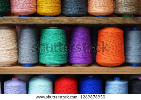 Set of colored threads for sewing on coils. Pile of big colorful spools of thread. Colored thread spools of thread large class, textiles, background Royalty-Free Stock Photo #1269878950