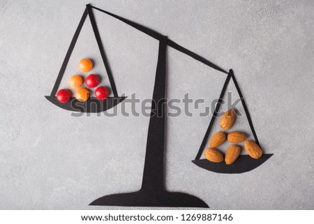 Weighing Scale Holding health and junk food. Sweets Are Unhealthy. Concept choice Healthy and fast Food.