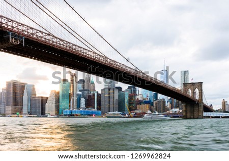 Brooklyn Bridge at sunset view. New York City, USA. Brooklyn Bridge is linking Lower Manhattan to Brooklyn.
