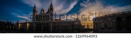 A sunset photo of the exterior facade of the Almudena Cathedral catholic church as seen from the Armory square of the Royal Palace of Madrid, or Palacio Real, in winter in Madrid, Spain, Europe.