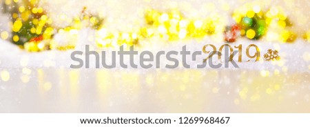 Snow with wooden 2019 and a snowflake. Christmas card in bright Golden lights