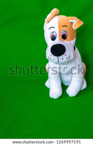 a child's toy on a green background - dog 