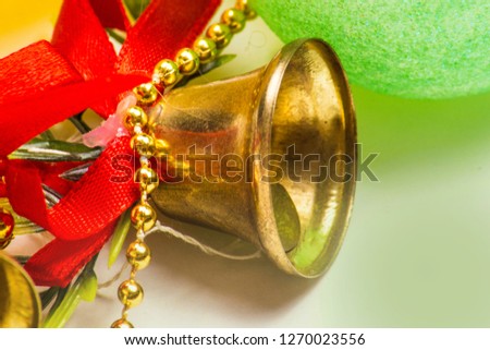 Closeup view of many beautiful old fashioned golden christmas bells hanging as new year toys, horizontal picture