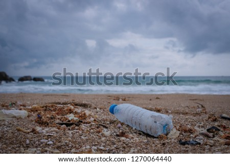Trash, plastic, garbage, bottle... environmental pollution on the beach. Royalty high-quality free stock photo image of trash, plastic bottle on the beach. Waste that polluted the ocean environmental