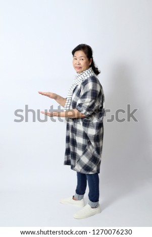 The elder Asian woman on the white background.
