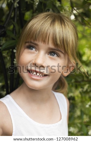 Close-up of a happy cute girl looking away