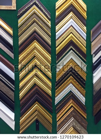 Selection of picture frame displayed on green wall