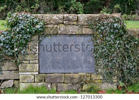 empty sign on a stone wall isolated on white background (copy-space available for design)