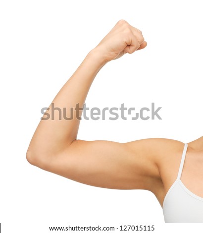 closeup picture of sporty woman flexing her biceps Royalty-Free Stock Photo #127015115